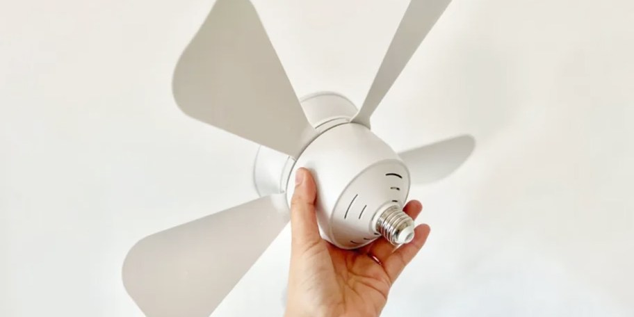 hand holding white socket ceiling fan 