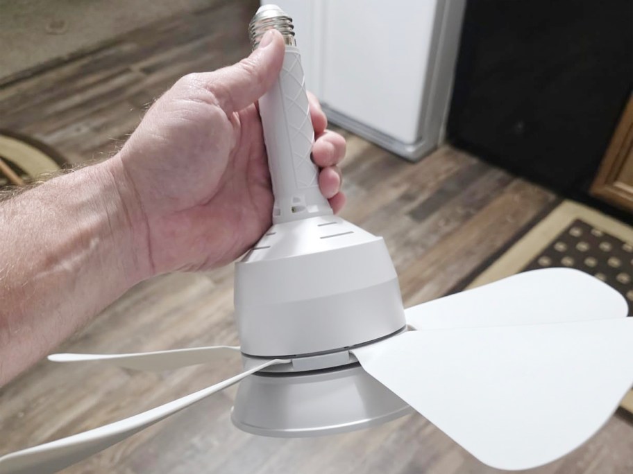 hand holding white socket ceiling fan 