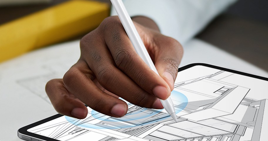 person using a stylus to draw on a tablet