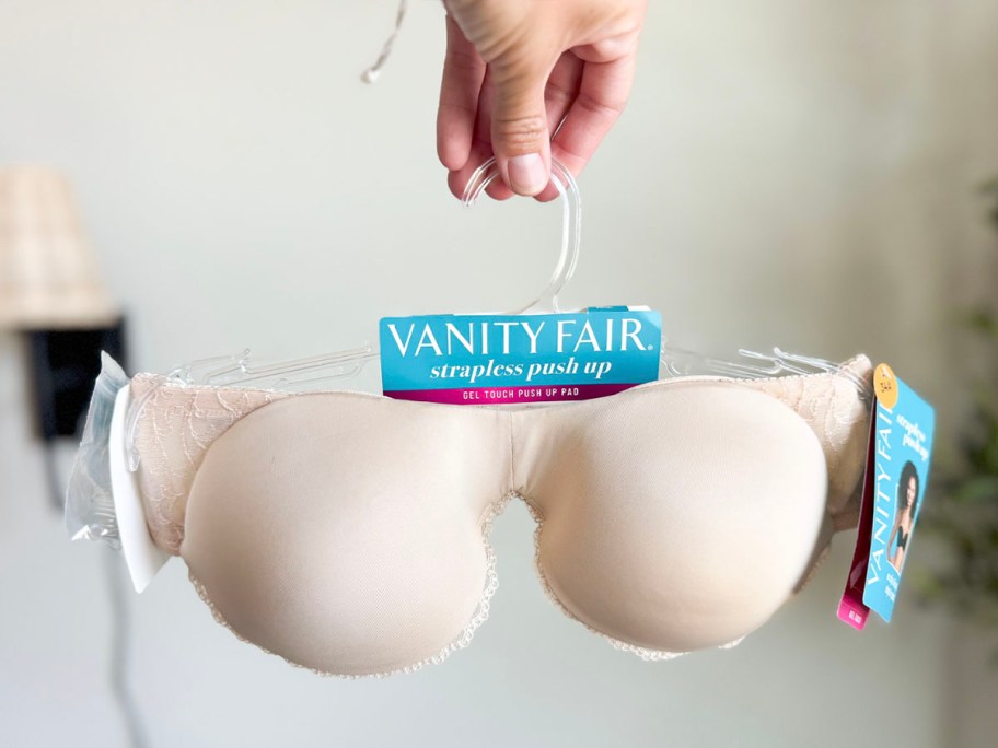 hand holding tan strapless bra 
