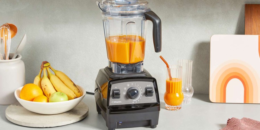 silver and black blender with orange smoothie on counter