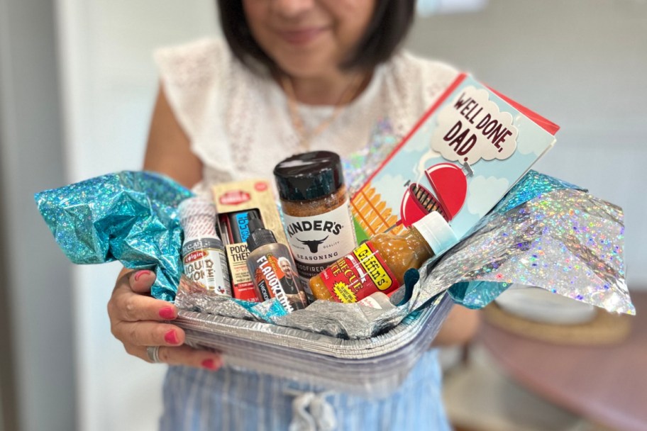 woman holding metal pans with mini sauces and grill items