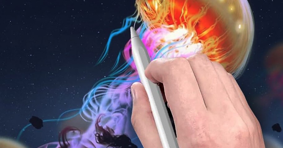 peson using a white stylus pen to draw a jellyfish on a tablet device