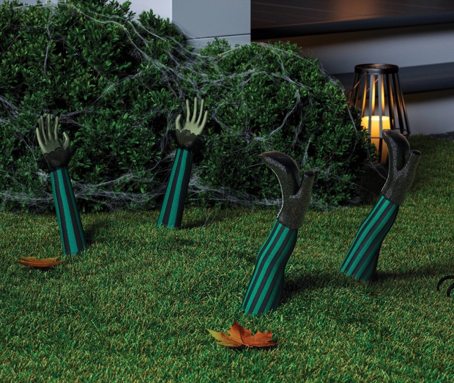 witch hands and feet yard stakes sticking in the ground
