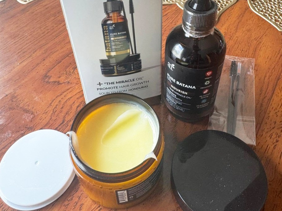 hair growth kit with oil serum and paste jars on table