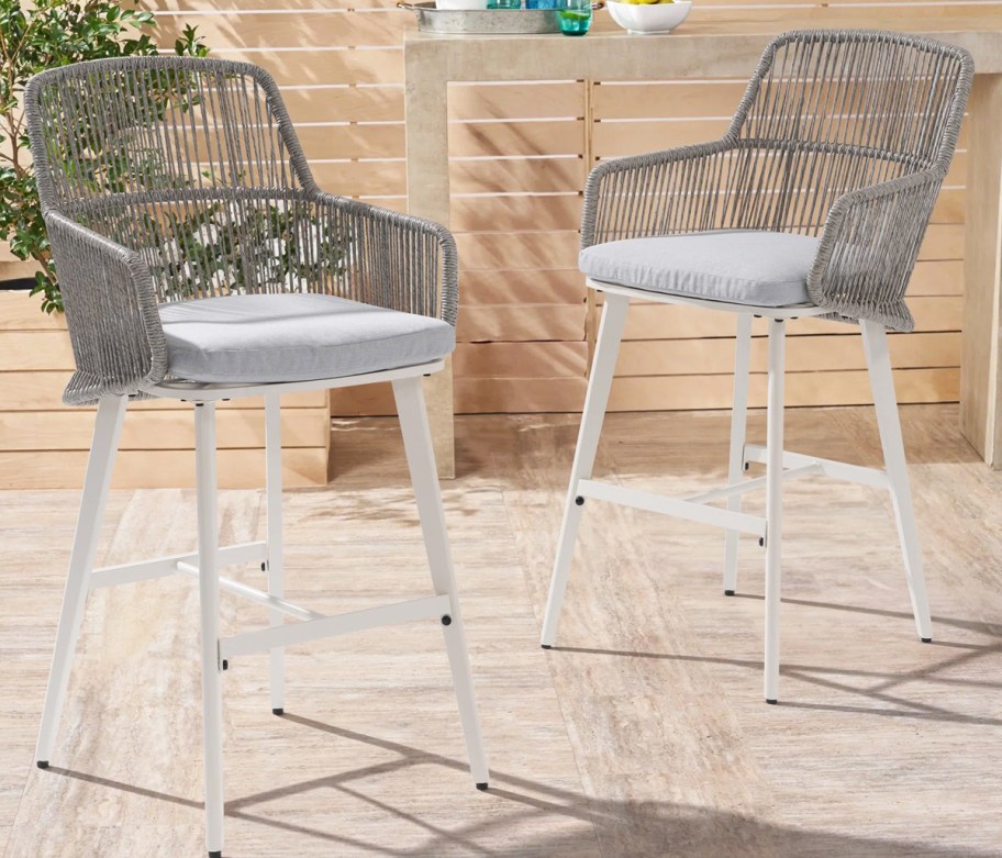 set of grey rattan bar stools with grey cushions and white legs