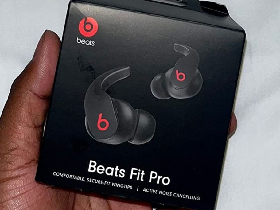 hand holding a box of Beats Fit Pro