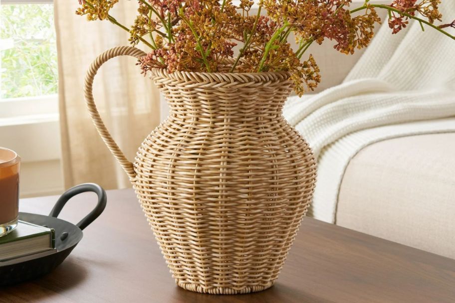A Faux Wood Rattan Pitcher Vase on a table