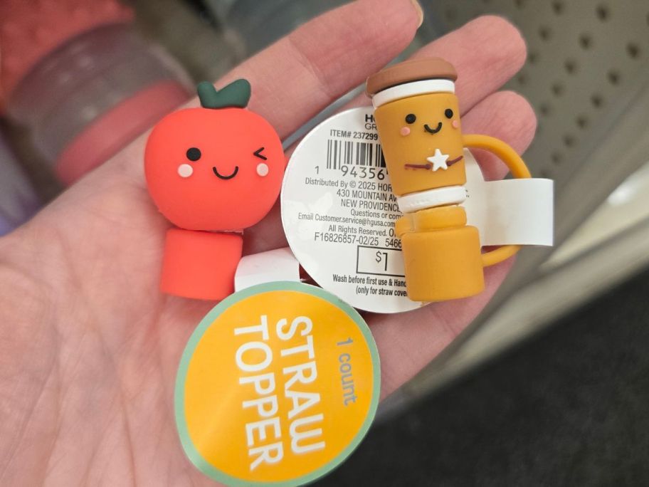 Hand holding two stroppers from Bullseye's Playground with an apple and a latte cup