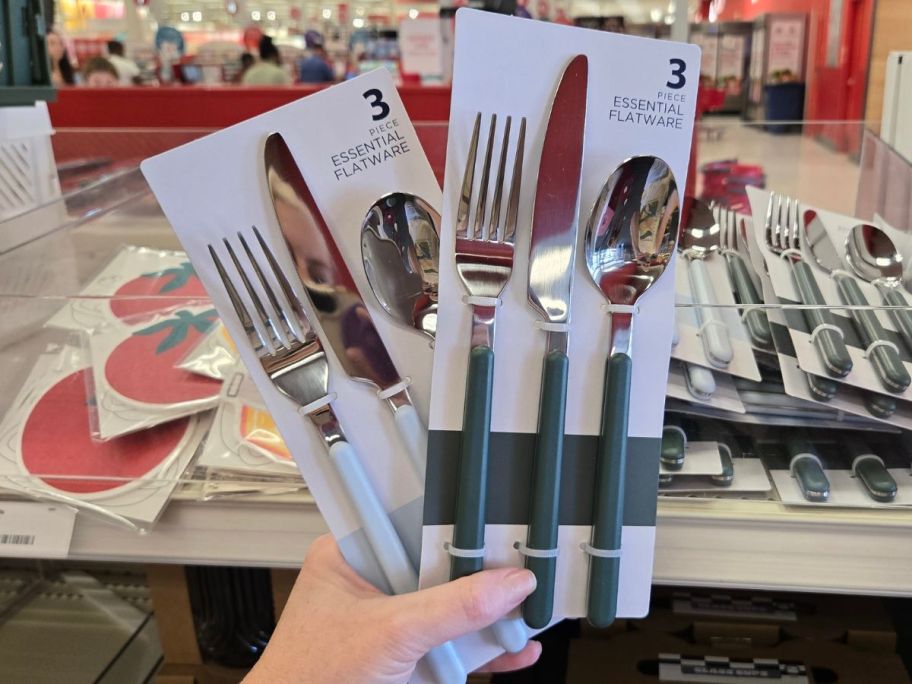Hand holding two 3-pack sof Cutlery from Target's Bullseye Playground