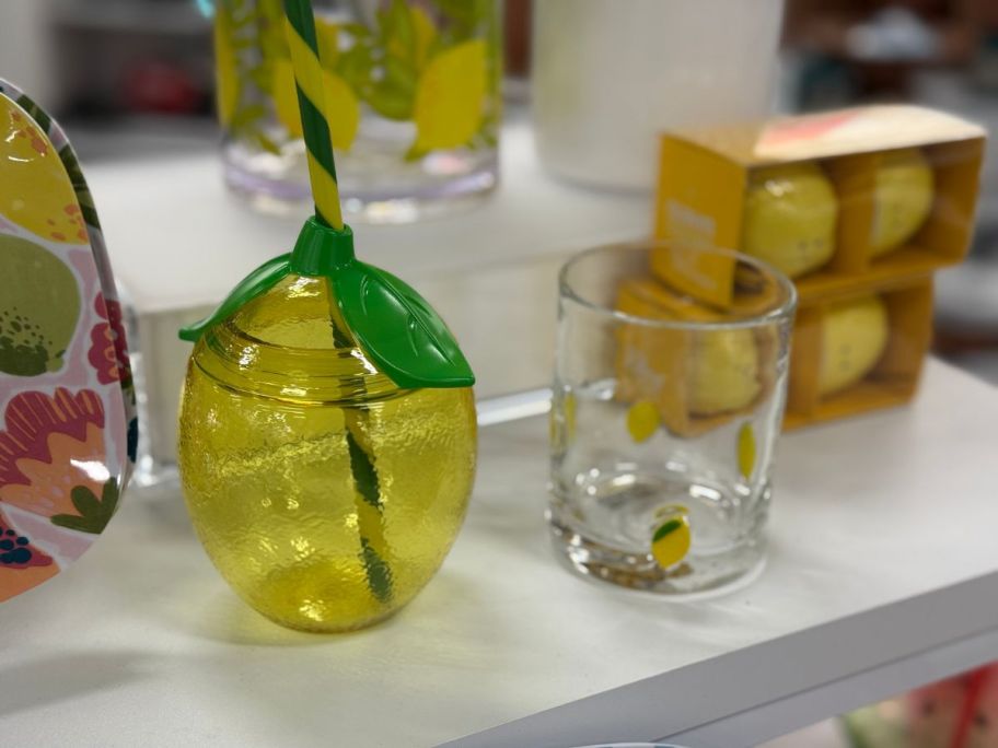A lemon tumbler and a glass
