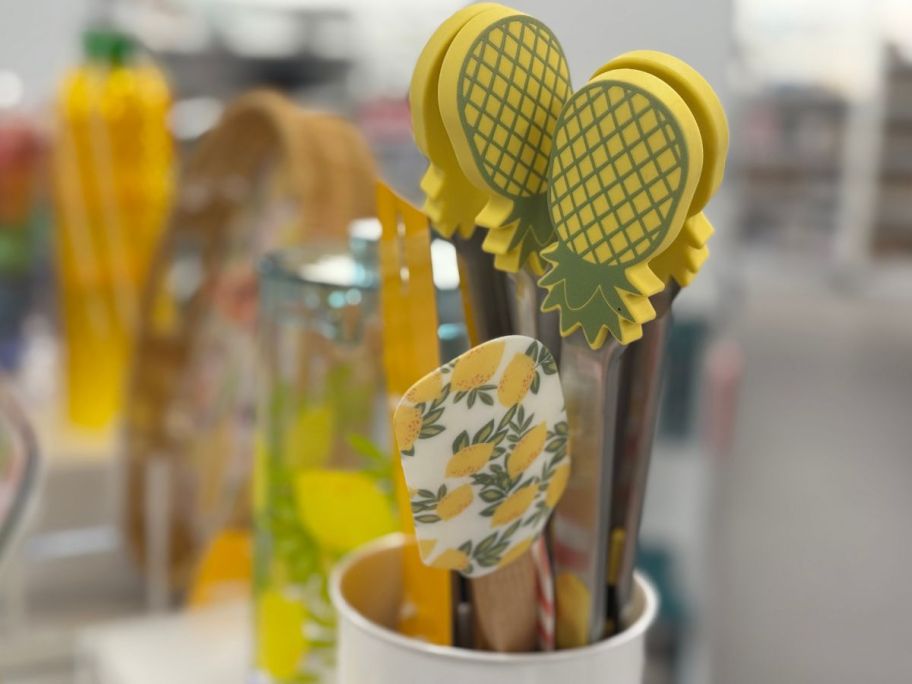 Several yellow spatuals in a canister