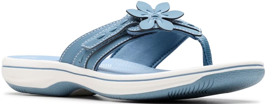 blue and white flip flop with flower on top