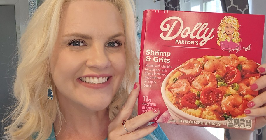 Dolly Partons Shrimp and Grits being held by a smiling woman