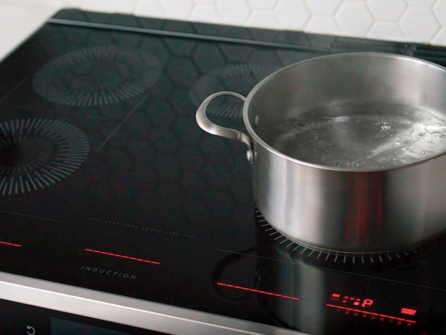 pot of water boiling on a black induction cooktop