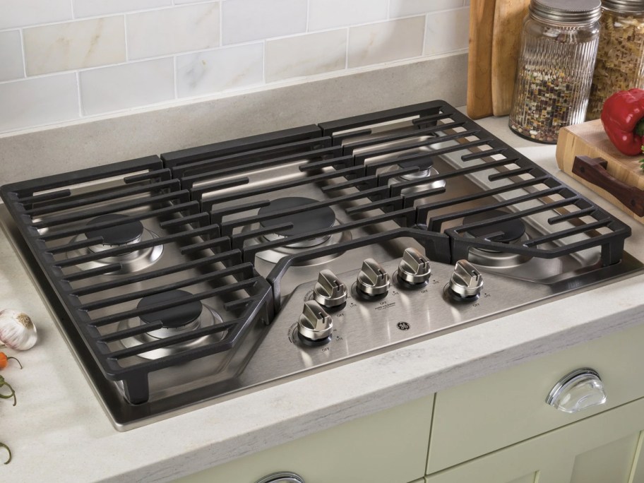 stainless steel and black gas cooktop on top of a counter