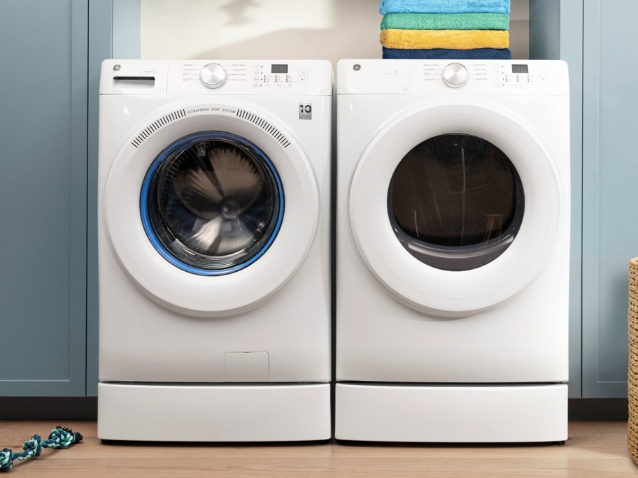 white front load washer dryer set in laundry room