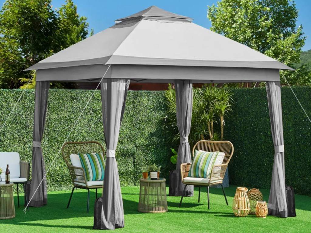 Grey gazebo outside on green grass