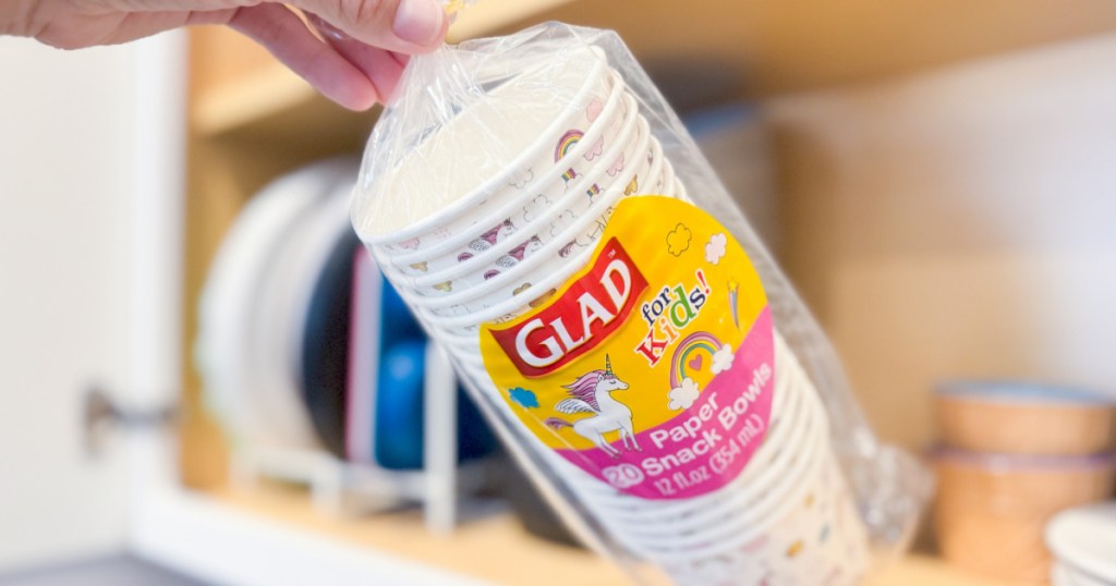 person grabbing package of glad for kids bowls from cabinet