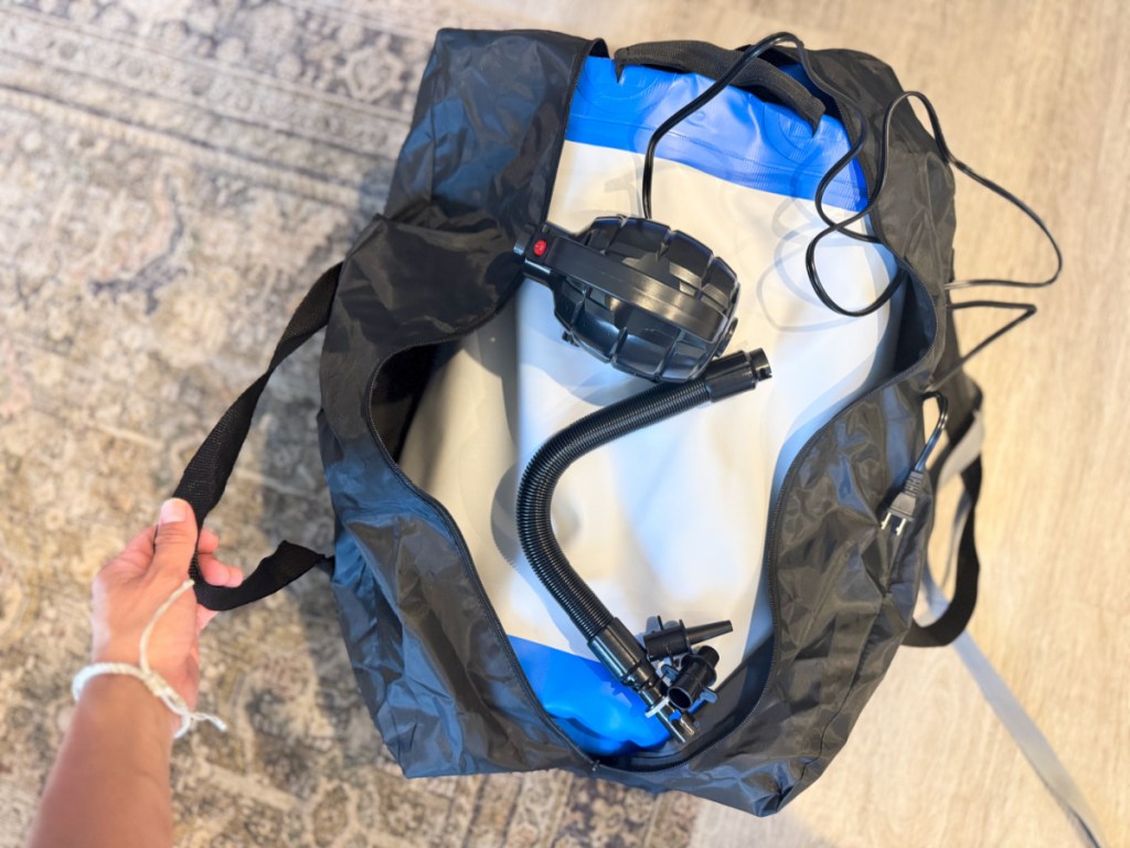 Inflatable gymnastics mat folded up inside black bag with air pump