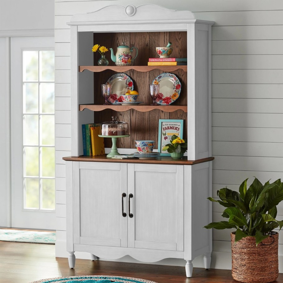 a tall white dining hutch in a kitchen