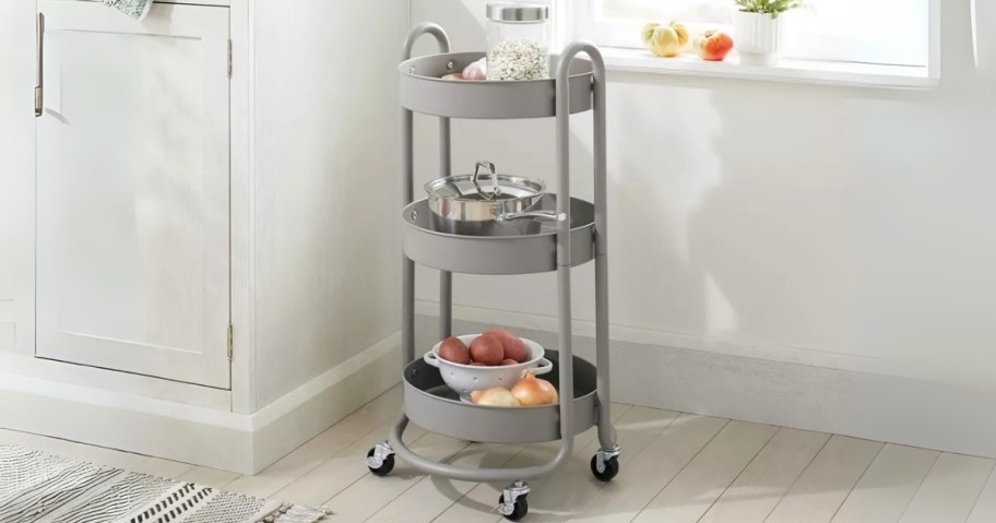 a grey round 3 tier metal utility cart in a kitchen