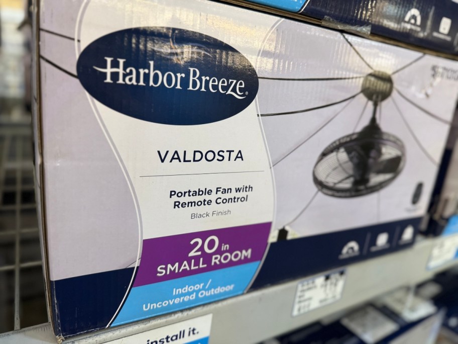 a box with an outdoor cage style fan on a Lowe's store shelf