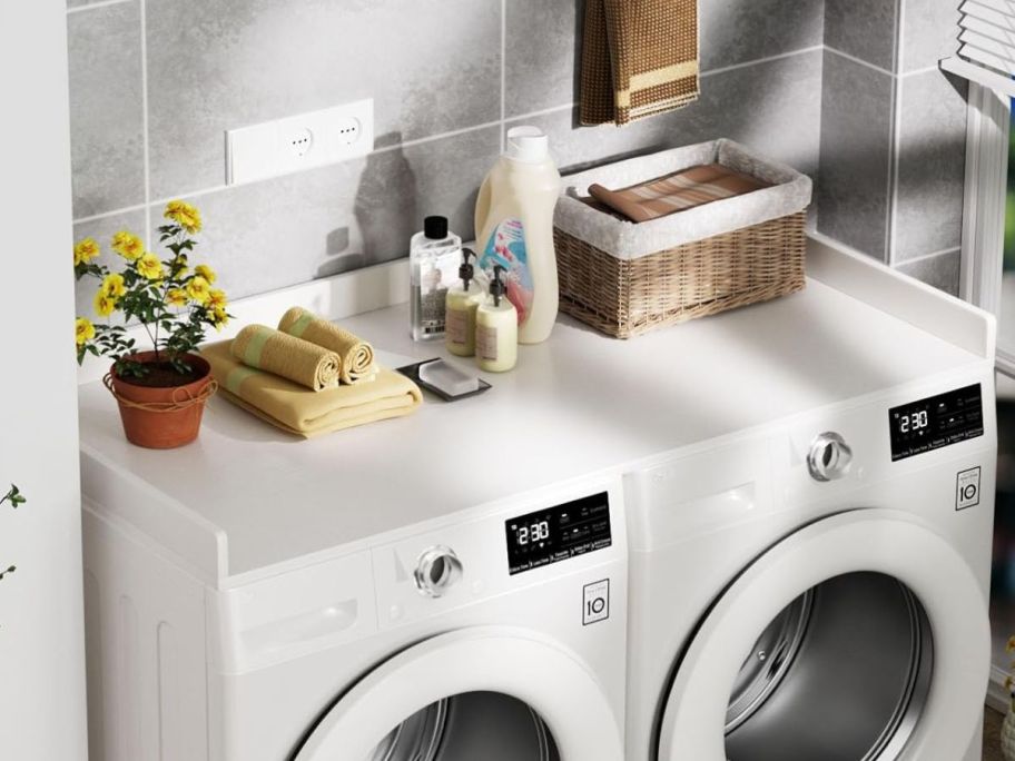 White HeyCody Washer Dryer Countertop topped with decor items and laundry essentials
