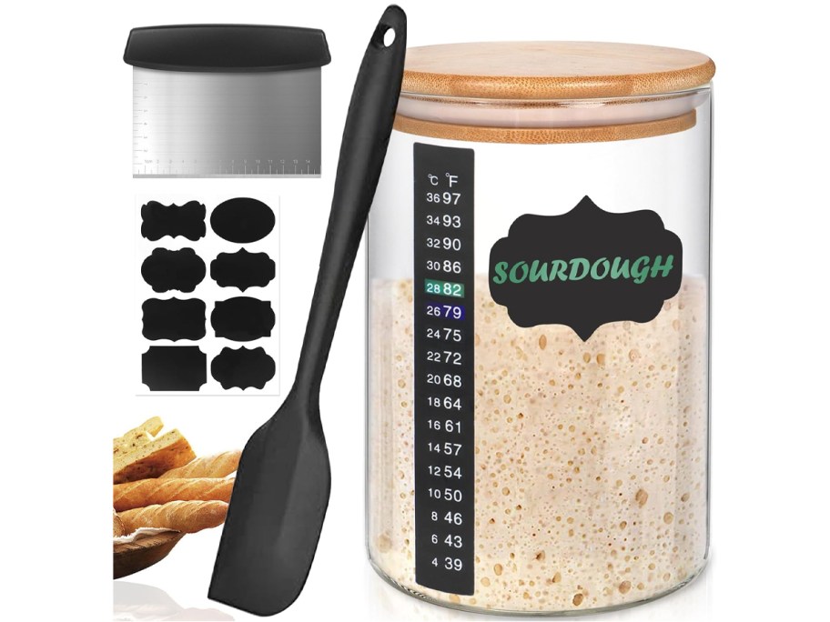 Kmise 34oz sourdough starter jar with bamboo lid, temperature strip, black spatula, stainless steel scraper, reusable chalkboard labels, and bread shown for display.
