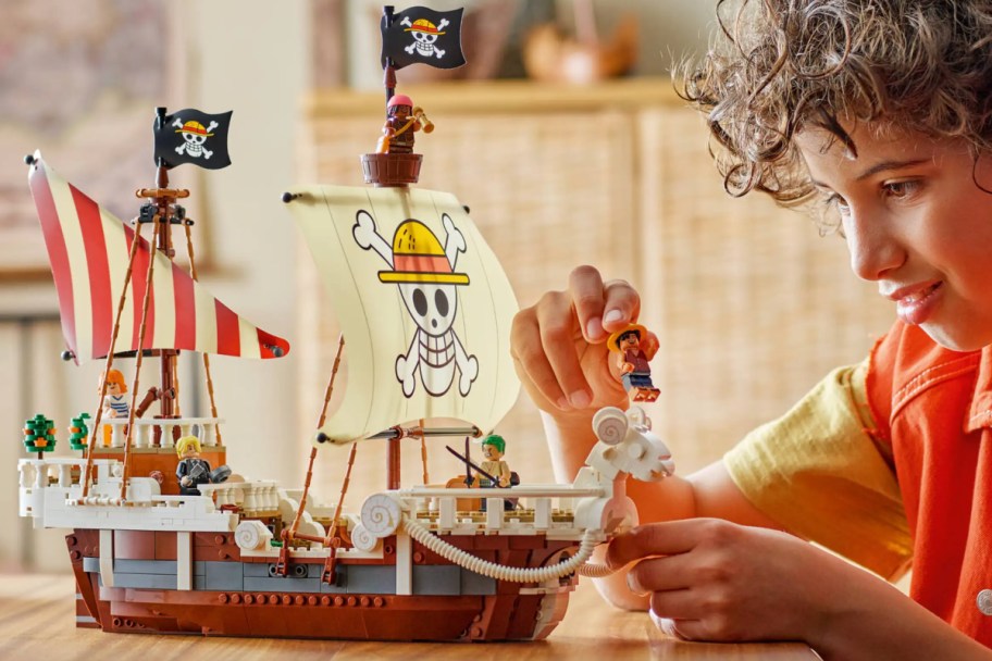 boy building lego pirate ship