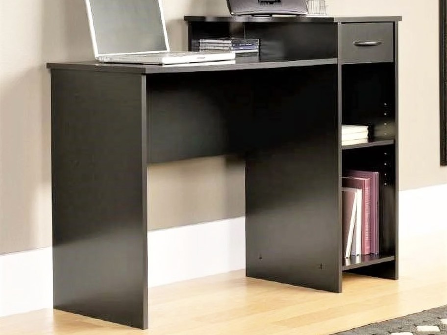 black desk with 2 shelves and storage drawer