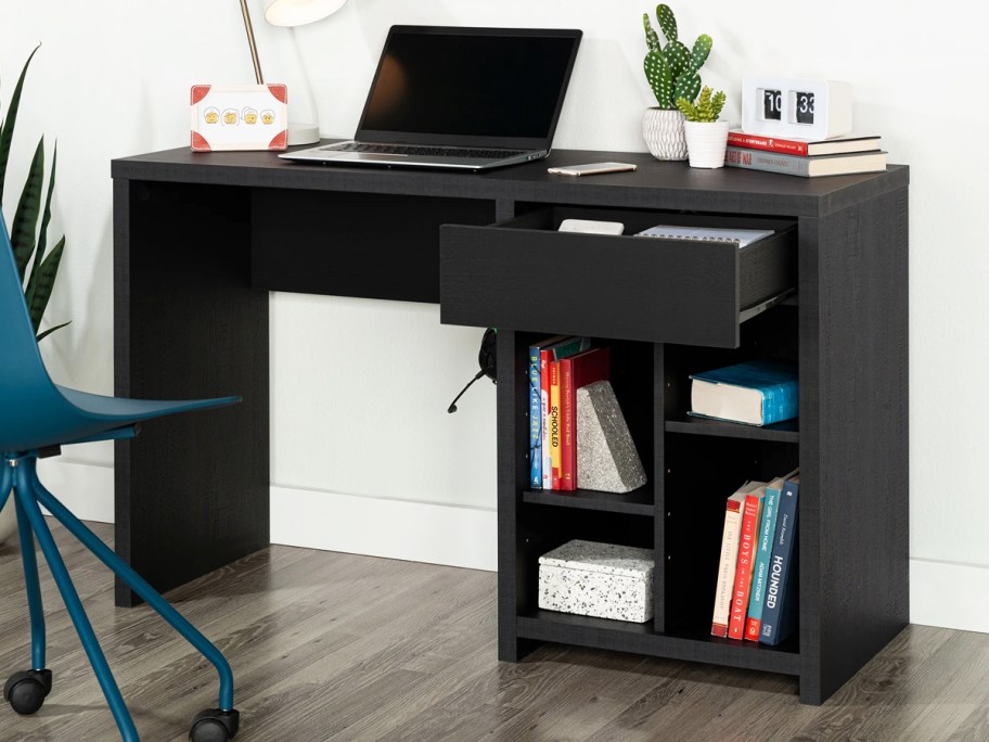 black desk with multiple shelves and storage drawer