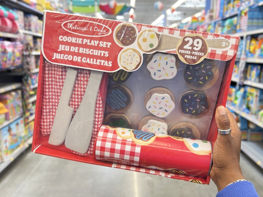 hand holding up Melissa & Doug Slice & Bake Cookie Play Set in store