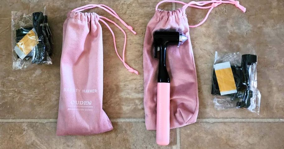 A pair of pink car window breakers that look like small hammers