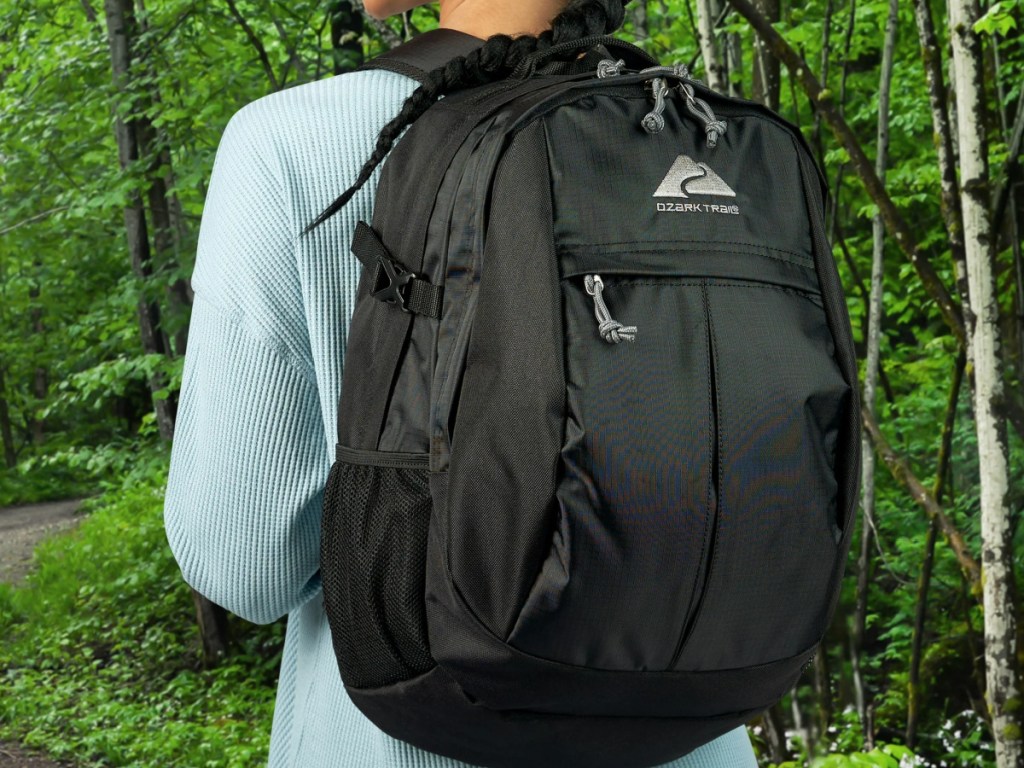 Woman wearing black Ozark Trail backpack