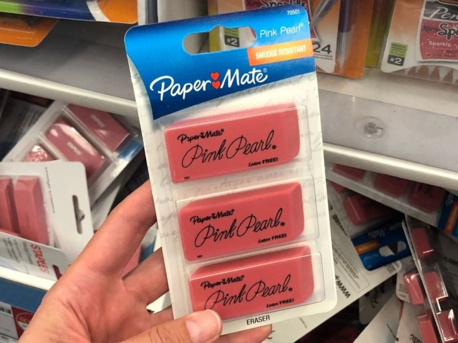 hand holding a 3-pack of Paper Mate Pink Pear Erasers