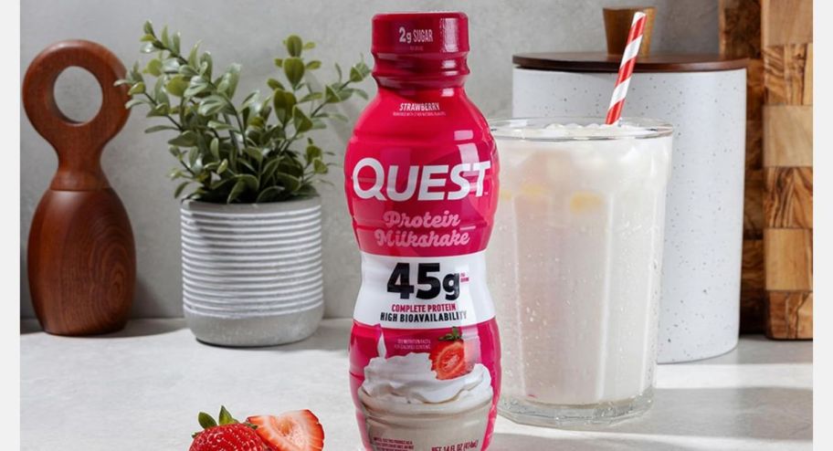 Quest strawberry milkshake displayed on top of a table 