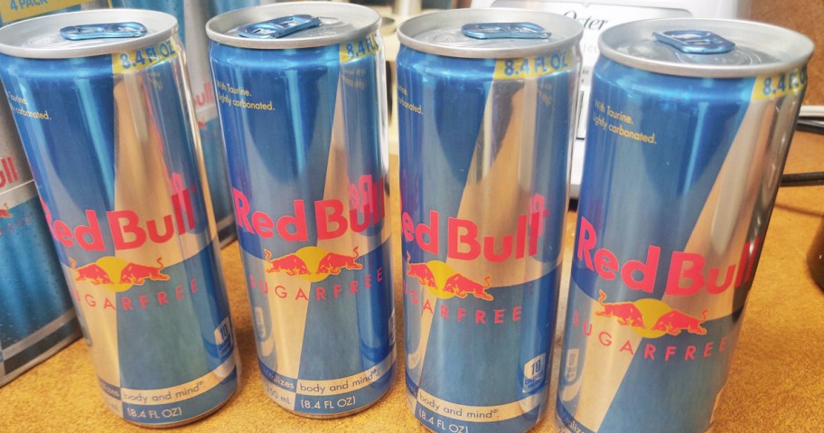 4 blue and silver cans of Red Bull Sugar Free