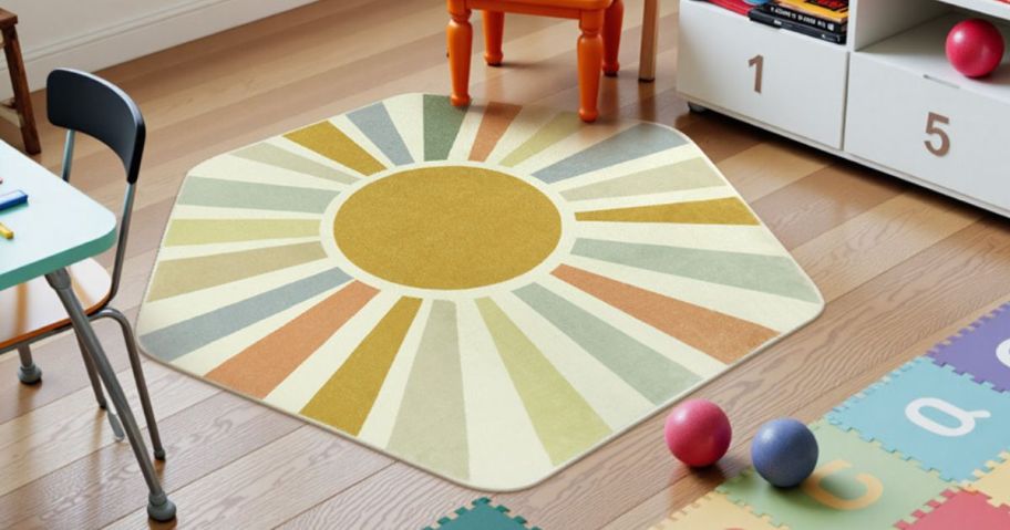 A rug with a sun on it in the middle of a classroom