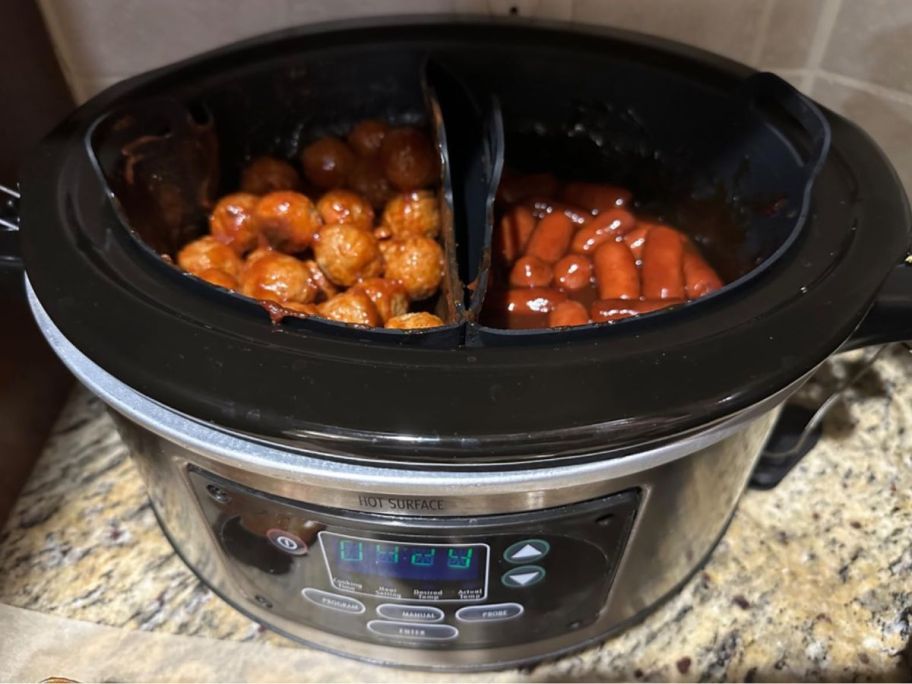 A ChefAid Slow Cooker Divider Liners with meatballs on one side and cocktail franks on the other