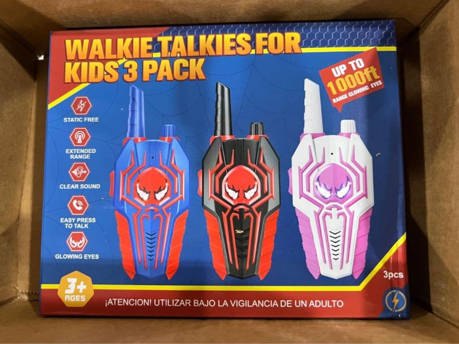 Three kids walkie talkies with Spiderman-like logo on them in a box