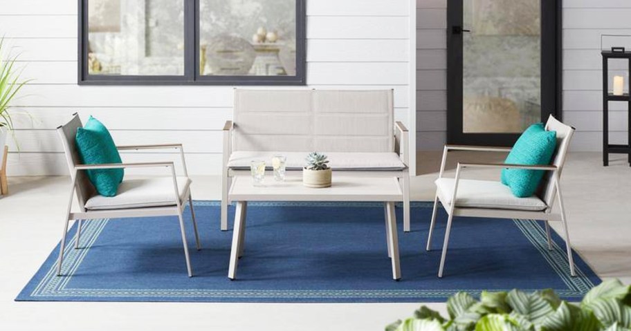 white patio chairs and matching loveseat with coffee table
