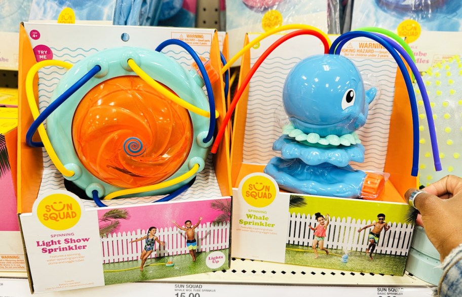 hand touching kids sprinklers on store shelf