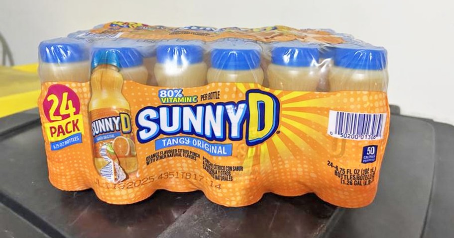 case of SunnyD bottles on black table