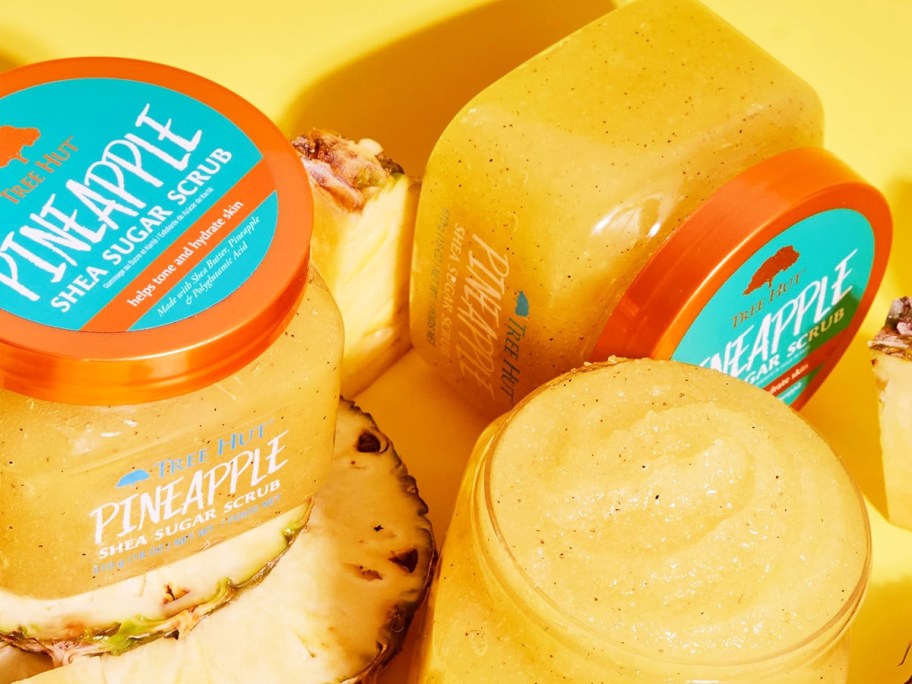 yellow jars of Tree Hut Shea Sugar Body Scrub in Pineapple scent