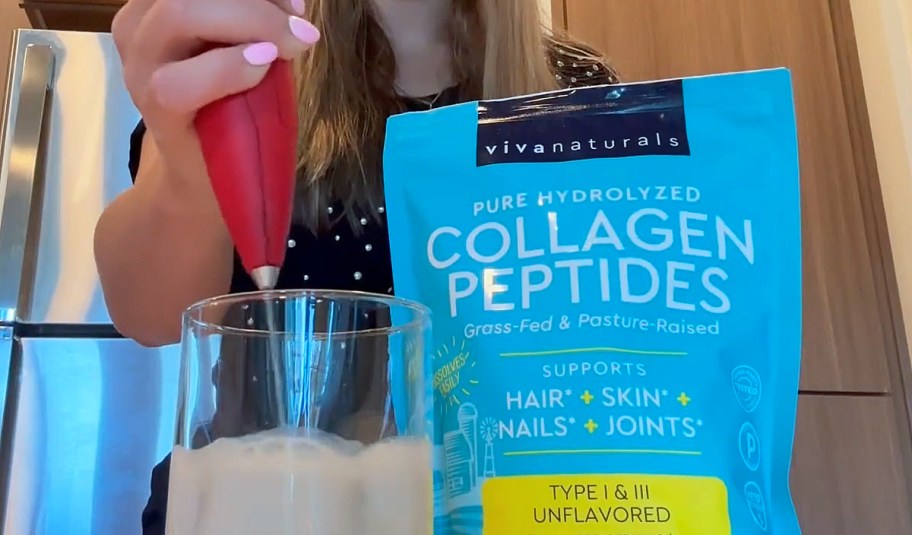 woman using handheld frother to blend collagen peptides into milk