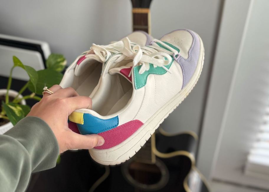 hand holding colorful court sneakers