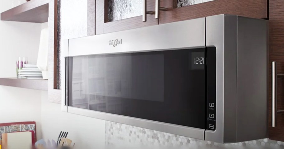 thin silver and black microwave under cabinets in kitchen