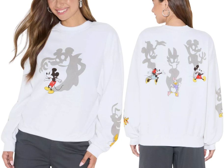 A woman wearing a white Mickey Mouse sweatshirt