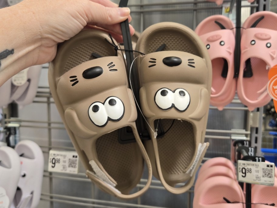 woman holding Wonder Nation Toddler Girls Critter Slide Sandals at walmart